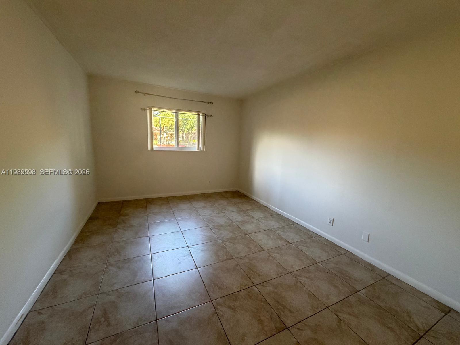 253 South Cypress Road, Unit 214 Pompano Beach, FL 33060 - Photo 7 of 25 an empty room with a white door