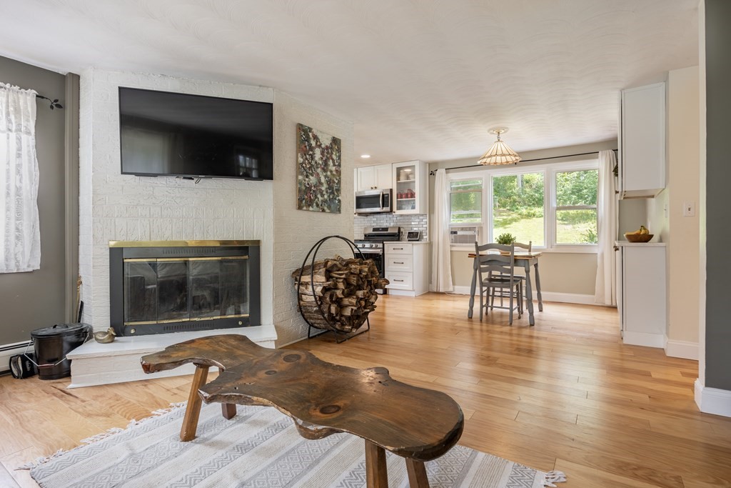 22 Parlee Road Chelmsford, MA 01824 - Photo 7 of 34 a living room with furniture a flat screen tv and a fireplace