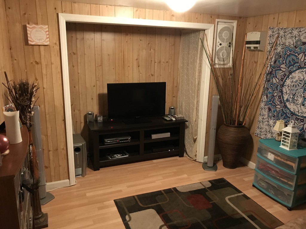 192 Morrison Road Taunton, MA 02718 - Photo 13 of 21 a room with a flat screen tv and a door