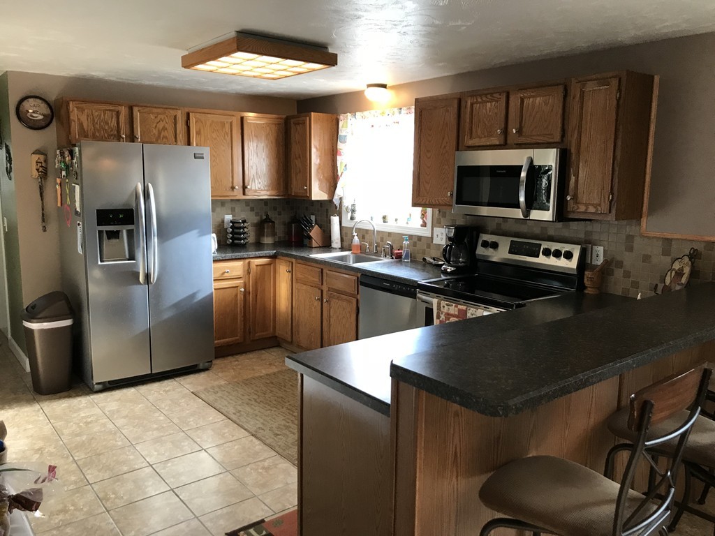 192 Morrison Road Taunton, MA 02718 - Photo 2 of 21 a kitchen with stainless steel appliances granite countertop a sink a stove and a refrigerator