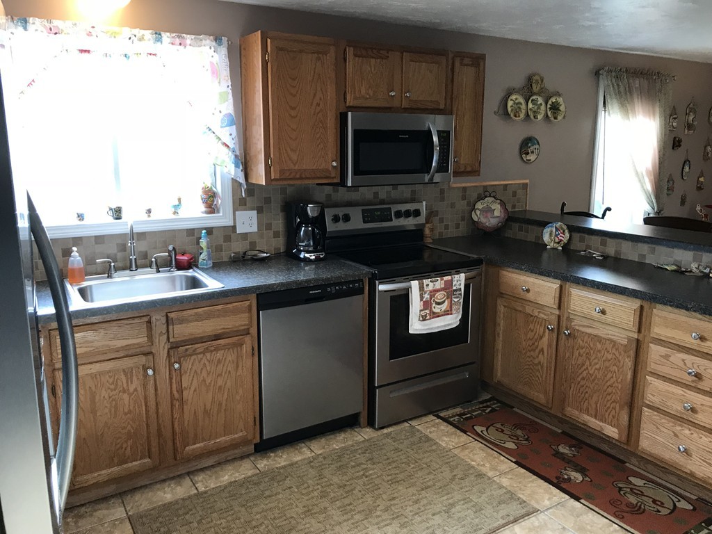 192 Morrison Road Taunton, MA 02718 - Photo 3 of 21 a kitchen with stainless steel appliances a stove a sink and a microwave