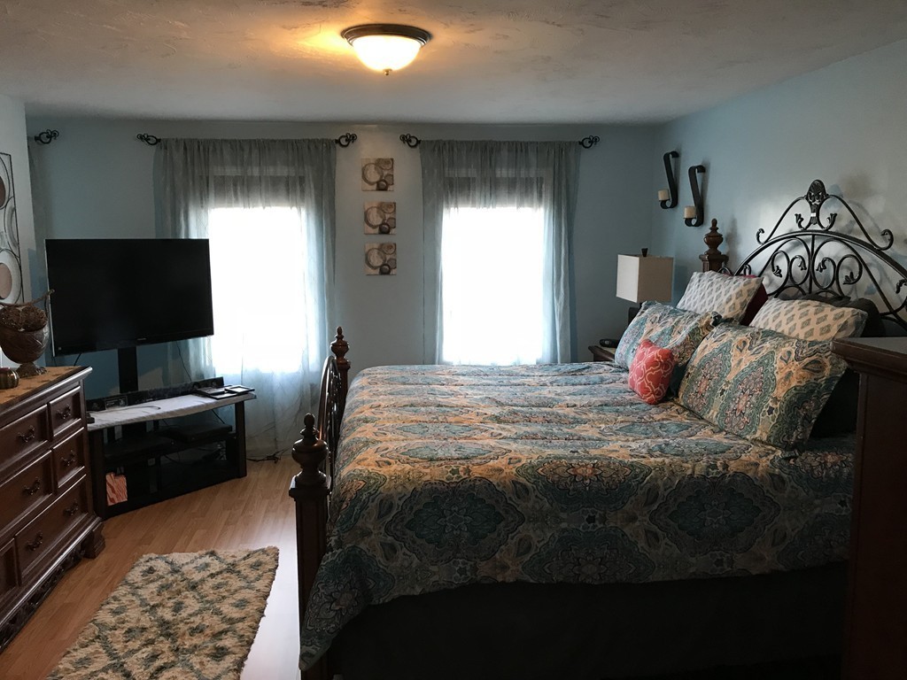 192 Morrison Road Taunton, MA 02718 - Photo 7 of 21 a bedroom with a bed and a tv