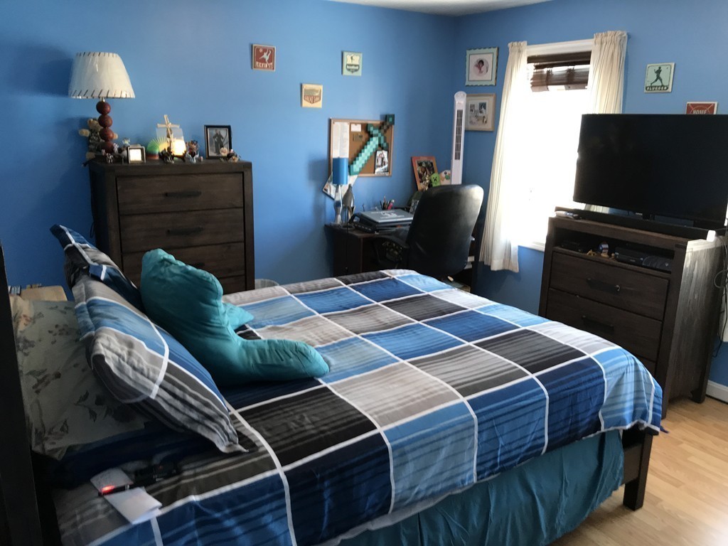 192 Morrison Road Taunton, MA 02718 - Photo 9 of 21 a bedroom with a bed and a flat screen tv