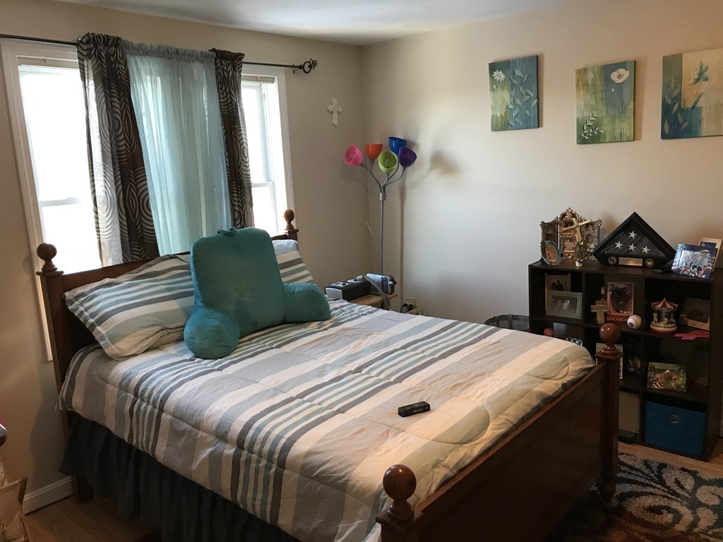 192 Morrison Road Taunton, MA 02718 - Photo 10 of 21 a bedroom with a bed and a chandelier