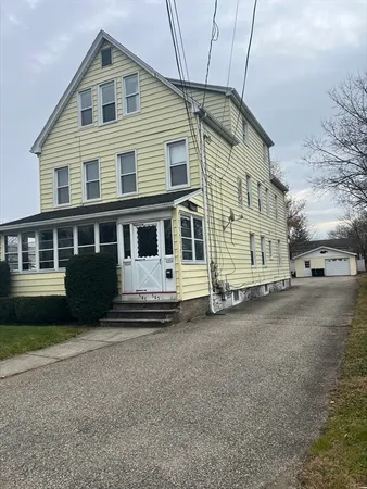a front view of a house with a garden