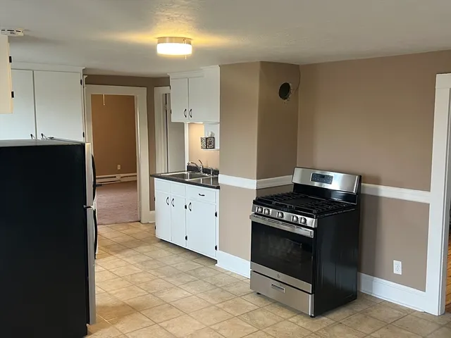 a kitchen with a stove and a refrigerator