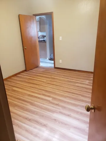 a view of a room with wooden floor