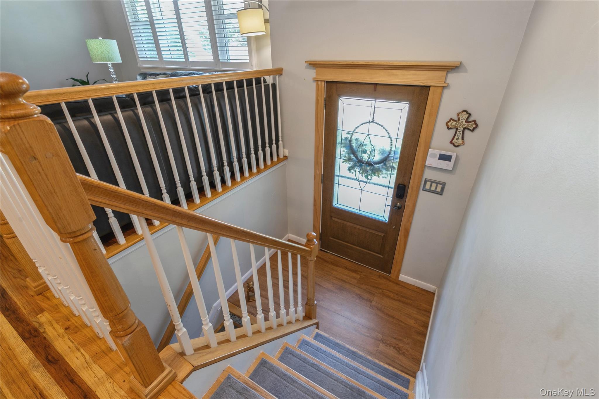 115 Clarendon Road Ronkonkoma, NY 11779 - Photo 4 of 45 Entryway featuring a wood-finish door with leaded glass, framed by natural wood trim