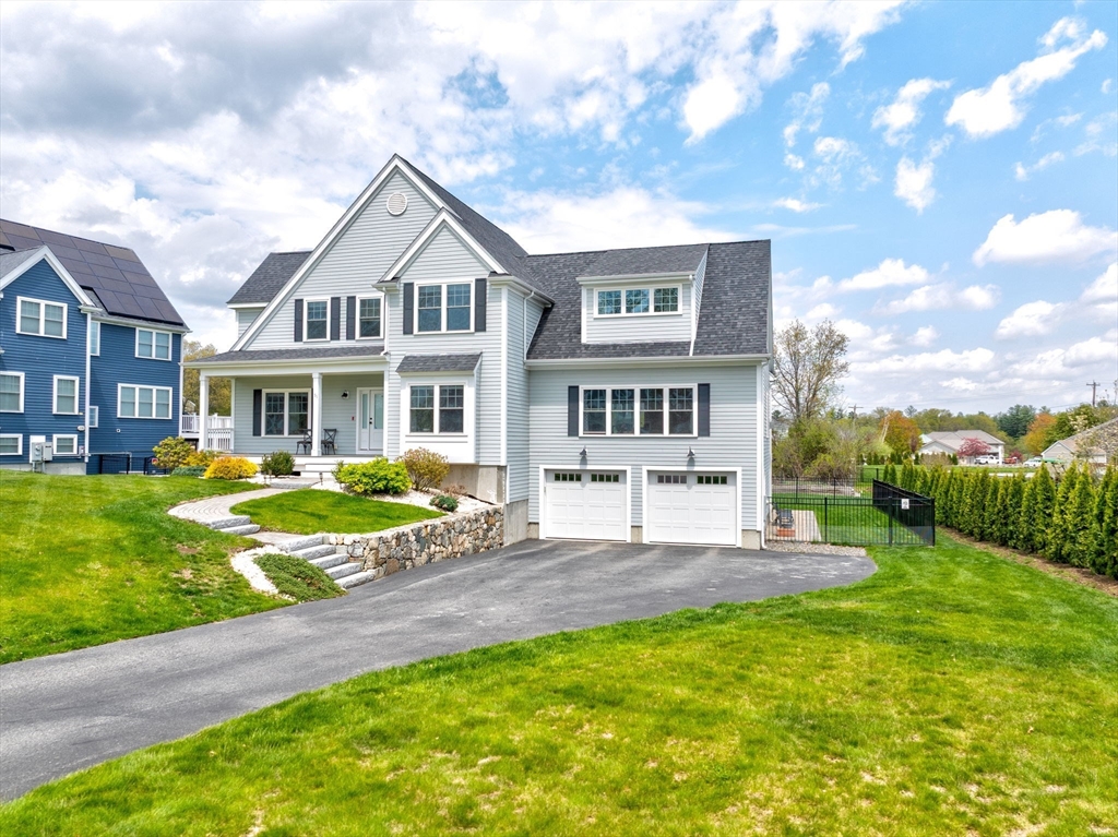 51 Tamarack Road Dracut, MA 01826 - Photo 2 of 39 a front view of a house with garden and porch