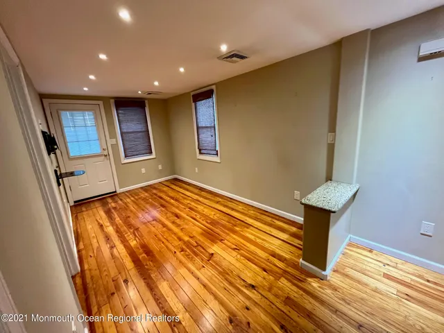 a view of hallway with wooden floor