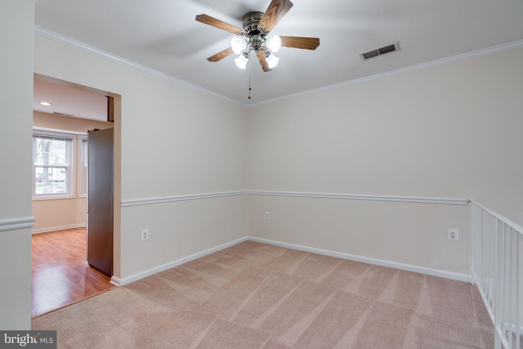 6032 Selwood Place Springfield, VA 22152 - Photo 14 of 42 Dining room has chair railing and ceiling fan.