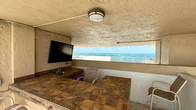 a view of a patio with table and chairs