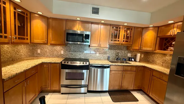 a kitchen with a sink stove and microwave