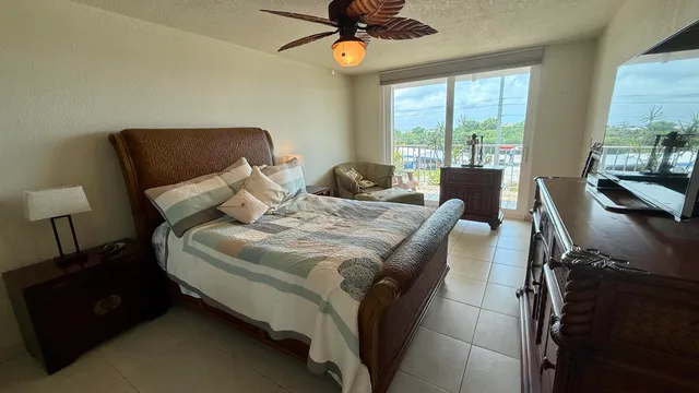 a bedroom with a bed window and a couch