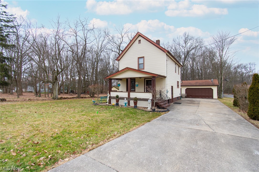 204 South Raccoon Road Youngstown, OH 44515 - Photo 3 of 25 View of front facade with a front lawn, a garage, and a porch