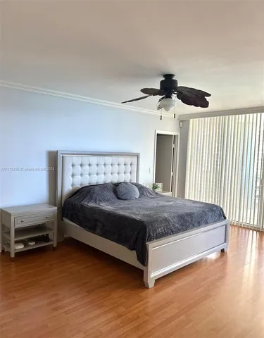 a bedroom with a bed and a ceiling fan