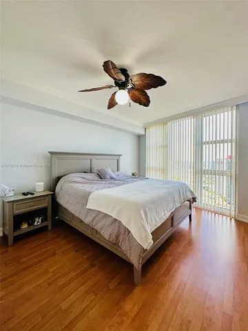 a bedroom with a bed and wooden floors