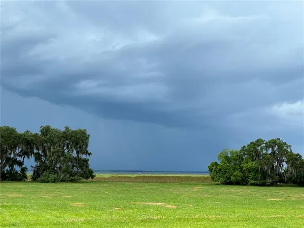 a view of a lake with a house in the background