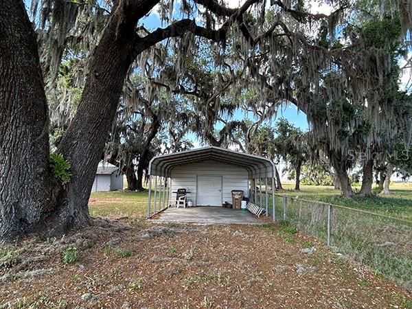 3650 Lake Tohopekaliga Road St. Cloud, FL 34772 - Photo 31 of 61 a front view of a house with garden