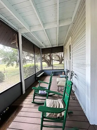 a view of a house with pool and sitting area