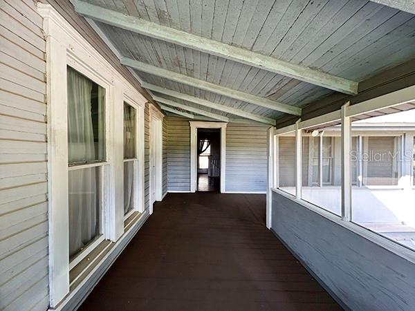 3650 Lake Tohopekaliga Road St. Cloud, FL 34772 - Photo 40 of 61 a view of a porch with wooden floor and stairs