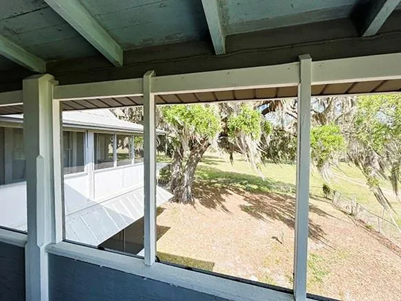 a view of a house with a yard and sitting area