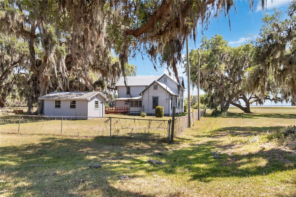 3650 Lake Tohopekaliga Road St. Cloud, FL 34772 - Photo 61 of 61 a house that has a tree in front of it