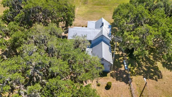 an aerial view of a house with a yard