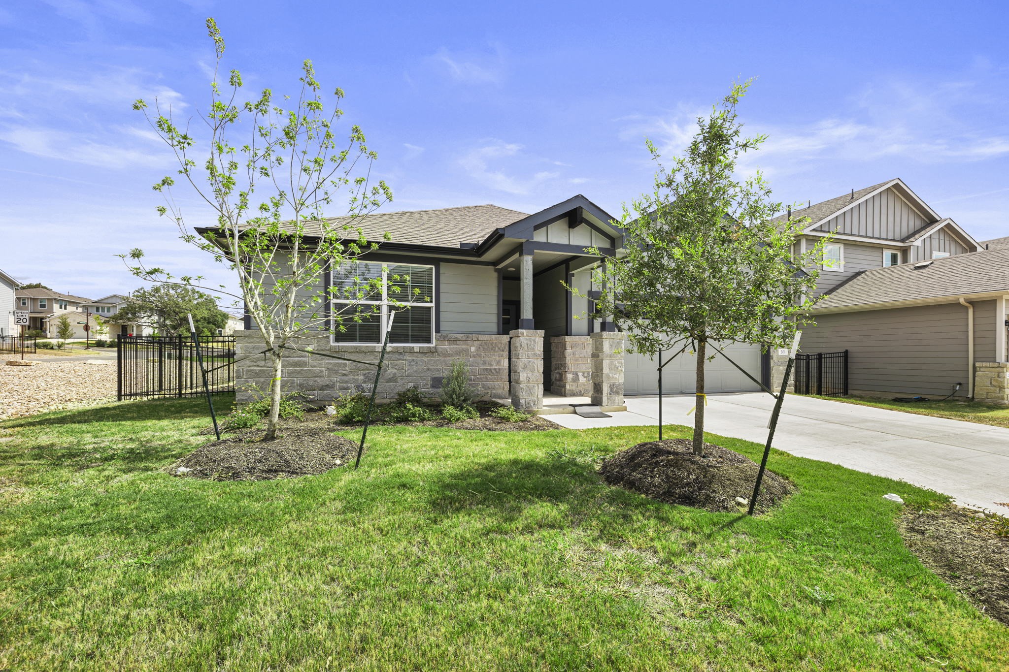 201 Merrick Road Georgetown, TX 78628 - Photo 20 of 20 a garden with a bench in front of the house