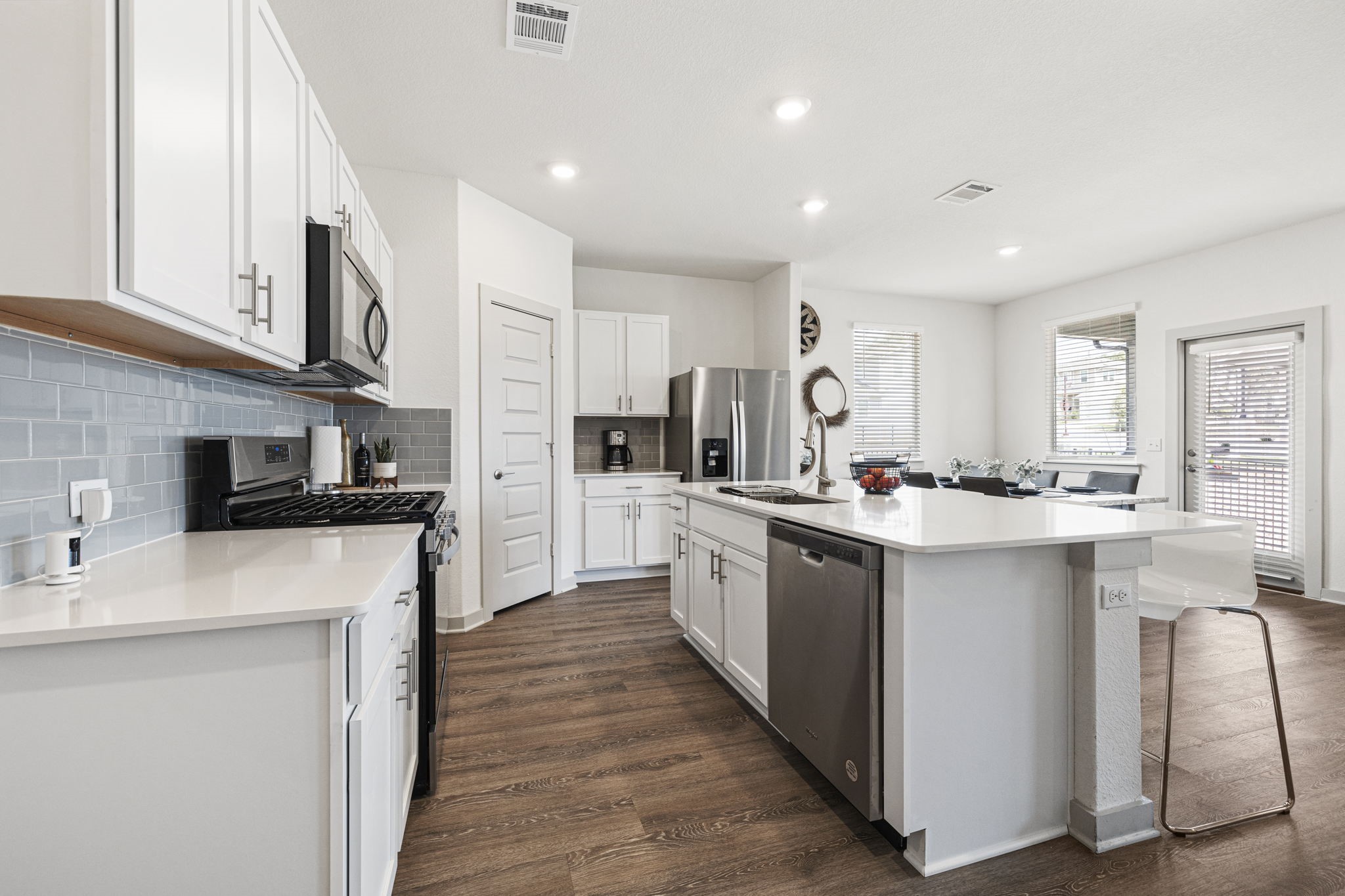 201 Merrick Road Georgetown, TX 78628 - Photo 2 of 20 a kitchen with stainless steel appliances granite countertop a sink stove and refrigerator