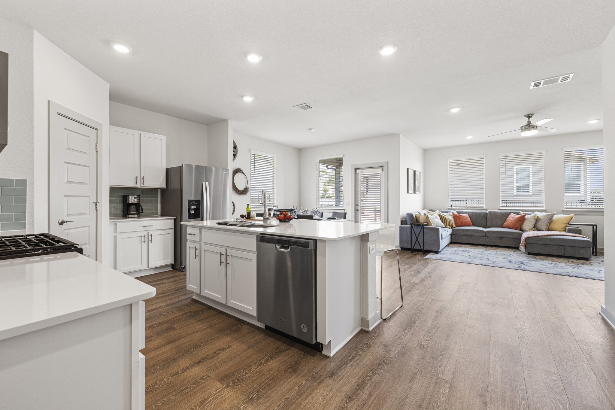 201 Merrick Road Georgetown, TX 78628 - Photo 4 of 20 a kitchen with white cabinets and stainless steel appliances