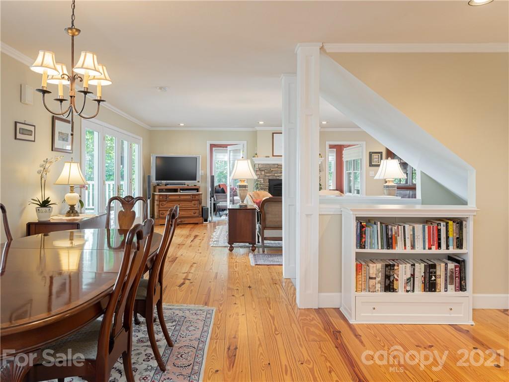 10 Powder Ridge Drive Asheville, NC 28803 - Photo 15 of 46 a view of a dining room with furniture a rug and wooden floor