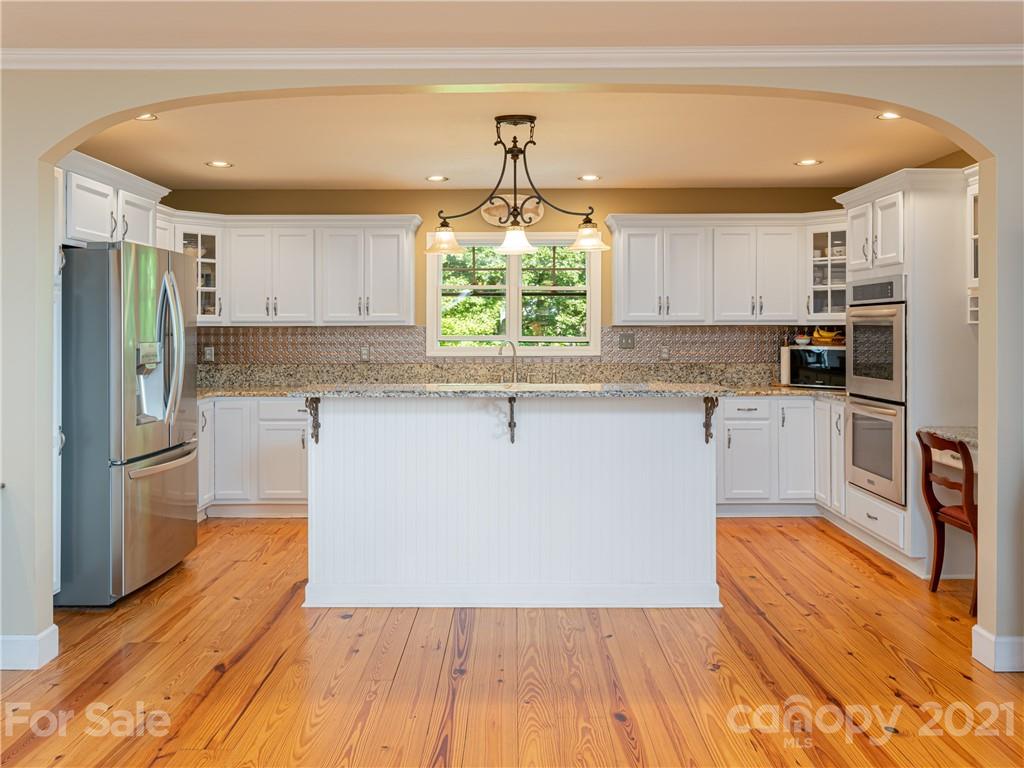 10 Powder Ridge Drive Asheville, NC 28803 - Photo 18 of 46 a kitchen with stainless steel appliances a refrigerator sink and microwave