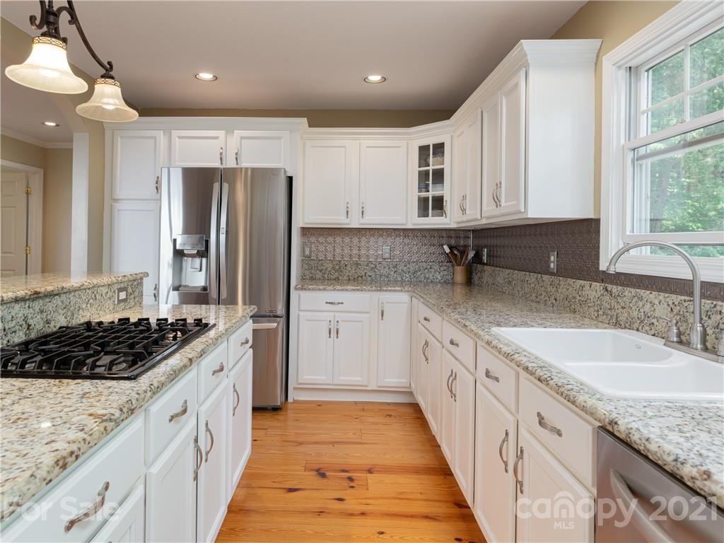 10 Powder Ridge Drive Asheville, NC 28803 - Photo 20 of 46 a kitchen with granite countertop a sink stove and refrigerator