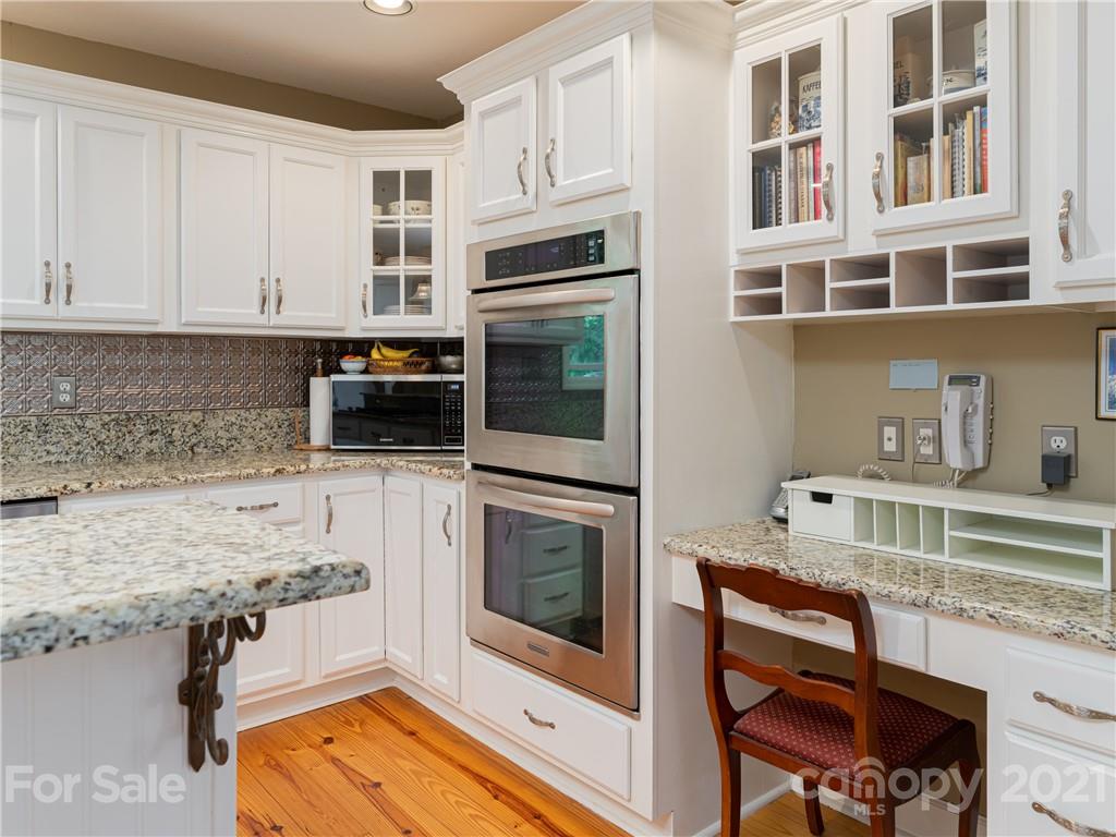 10 Powder Ridge Drive Asheville, NC 28803 - Photo 21 of 46 a kitchen with stainless steel appliances granite countertop a stove microwave and cabinets