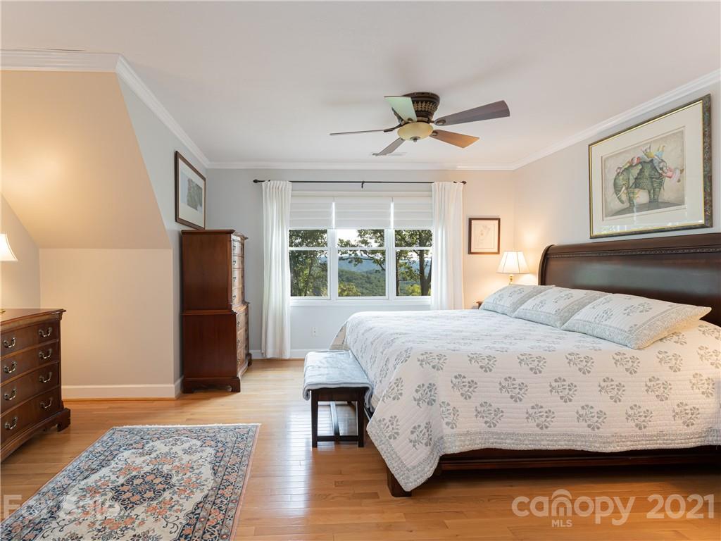 10 Powder Ridge Drive Asheville, NC 28803 - Photo 23 of 46 a bedroom with a bed and wooden floor