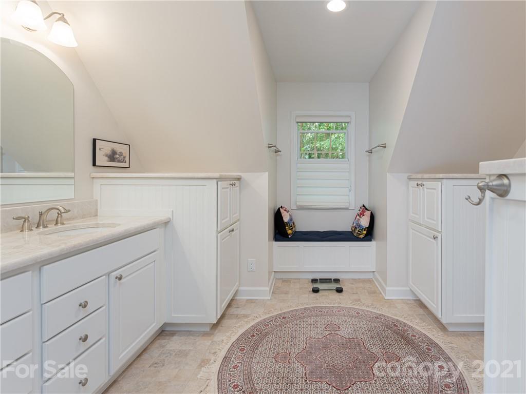 10 Powder Ridge Drive Asheville, NC 28803 - Photo 24 of 46 a bathroom with a sink a mirror and a bathtub