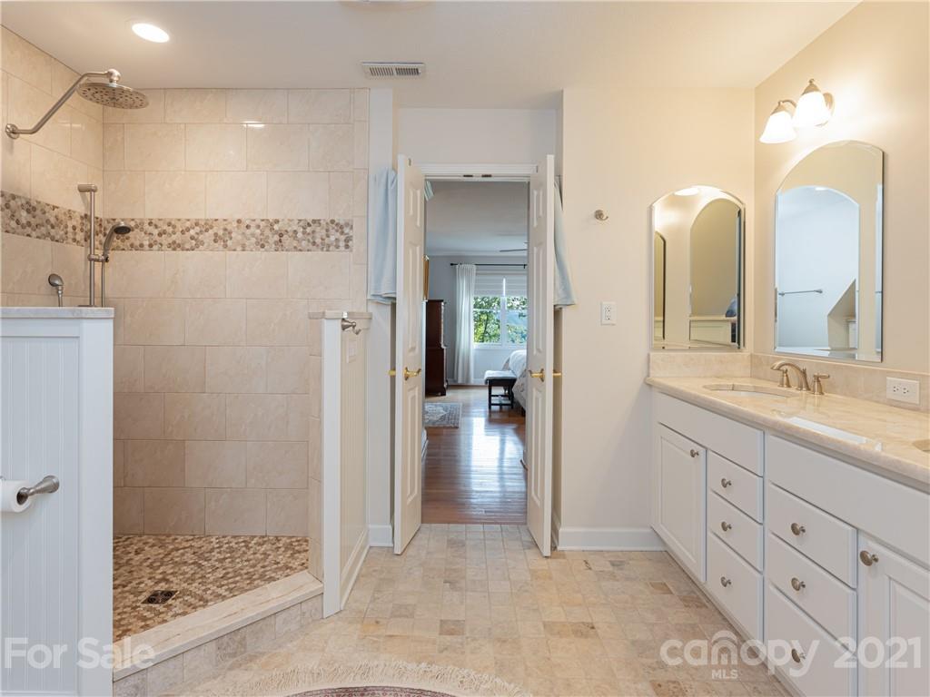 10 Powder Ridge Drive Asheville, NC 28803 - Photo 25 of 46 a bathroom with a double vanity sink mirror and shower
