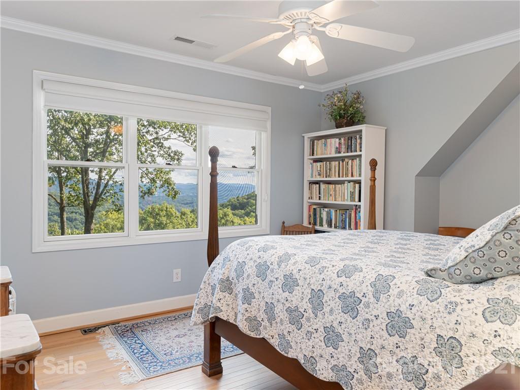 10 Powder Ridge Drive Asheville, NC 28803 - Photo 26 of 46 a bedroom with a bed closet and a large window