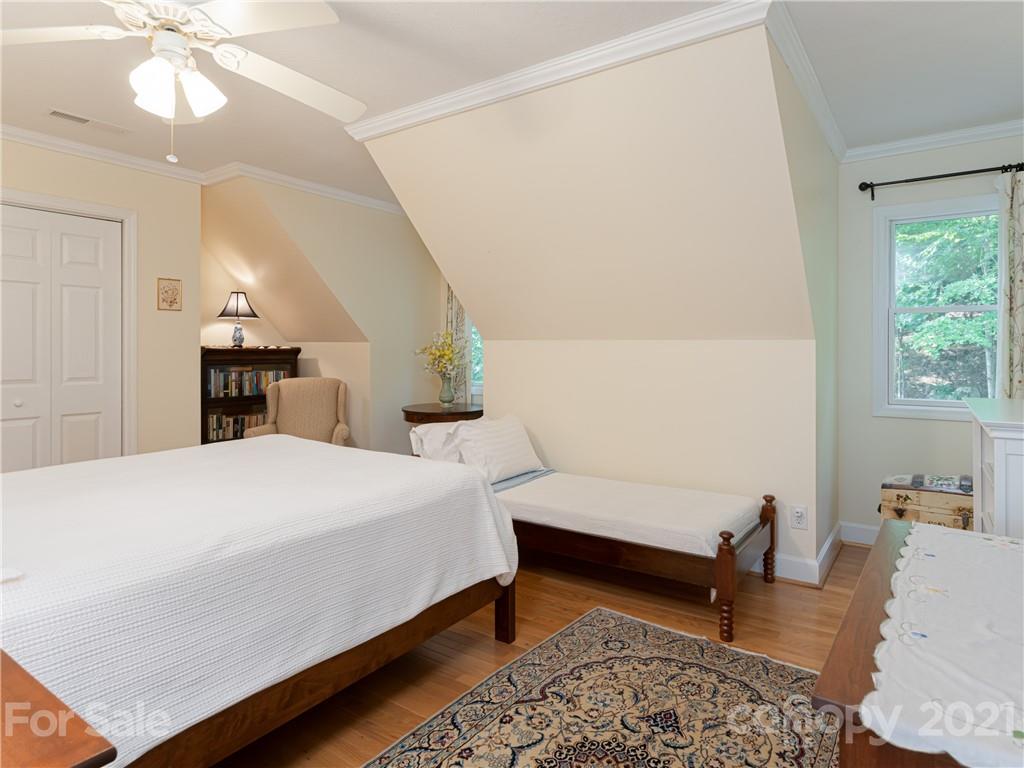 10 Powder Ridge Drive Asheville, NC 28803 - Photo 28 of 46 a bedroom with a bed and wooden floor