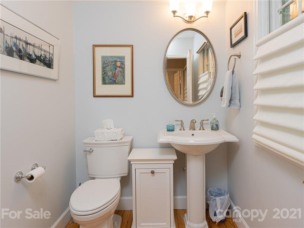 10 Powder Ridge Drive Asheville, NC 28803 - Photo 31 of 46 a bathroom with a toilet a sink and a mirror