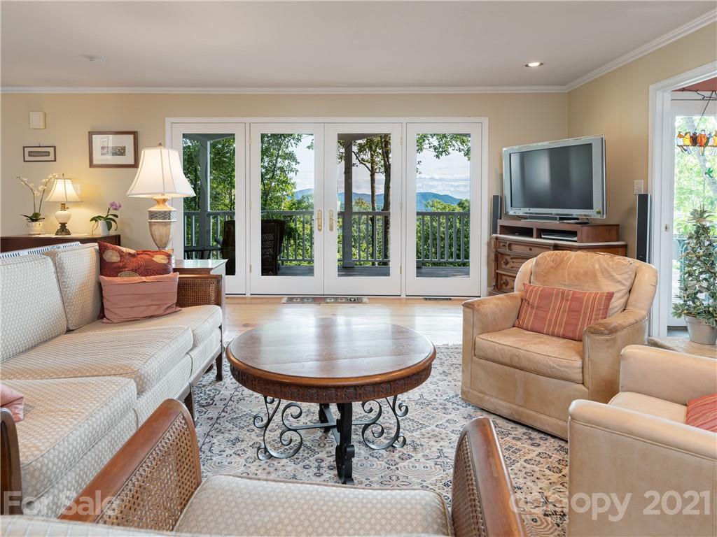 10 Powder Ridge Drive Asheville, NC 28803 - Photo 10 of 46 a living room with furniture a flat screen tv and a large window