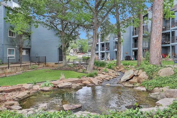 a backyard of a house with a garden and outdoor seating