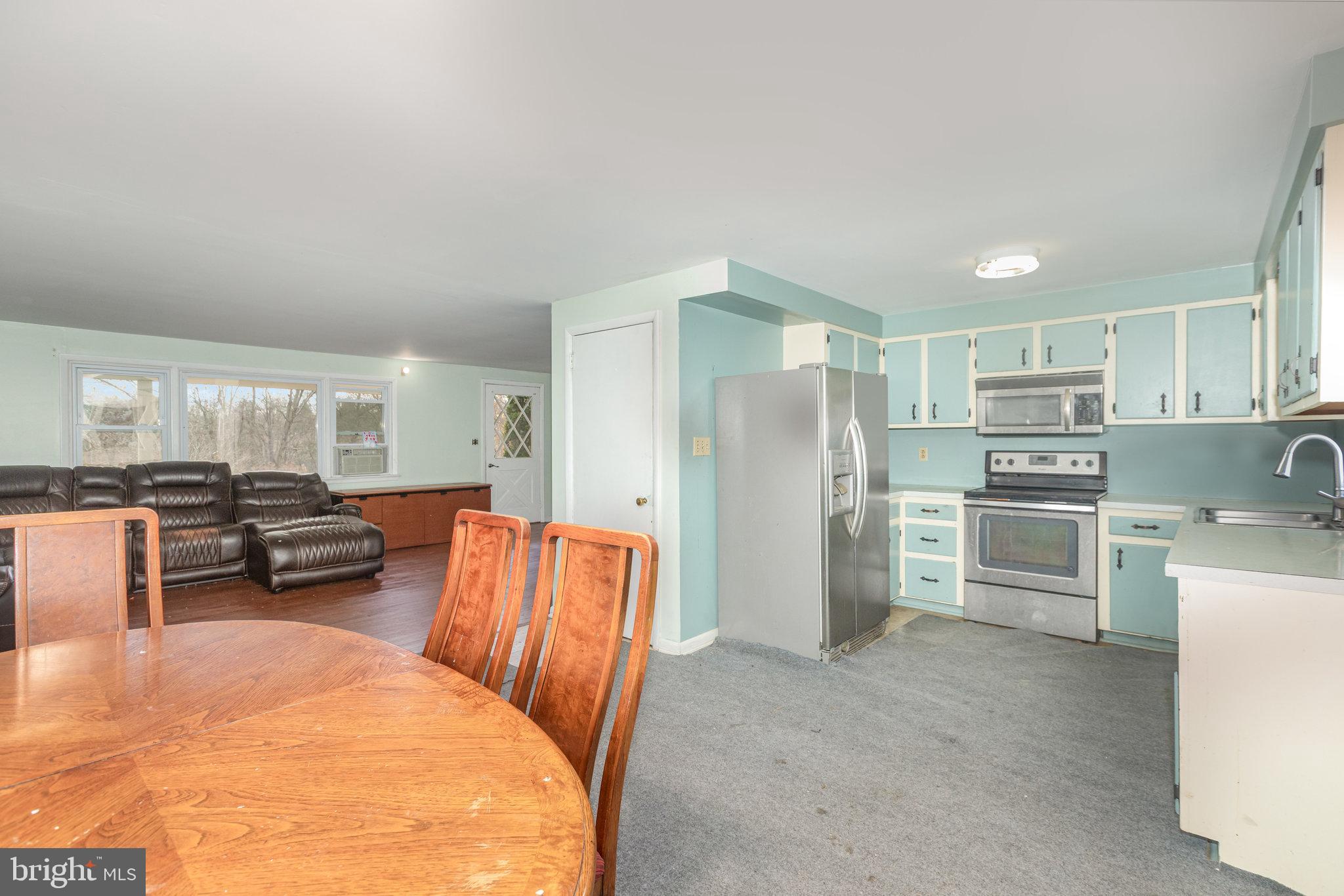 93 Beard Road Enola, PA 17025 - Photo 6 of 31 a kitchen with stainless steel appliances wooden floor and a refrigerator