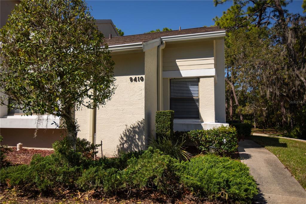 9410 Nakoma Way, Unit H Weeki Wachee, FL 34613 - Photo 1 of 29 a front view of a house with a yard