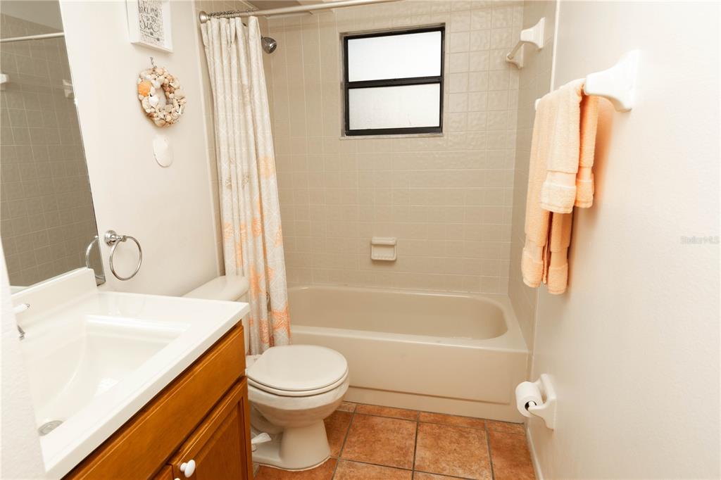 9410 Nakoma Way, Unit H Weeki Wachee, FL 34613 - Photo 11 of 29 a bathroom with a sink a toilet and shower