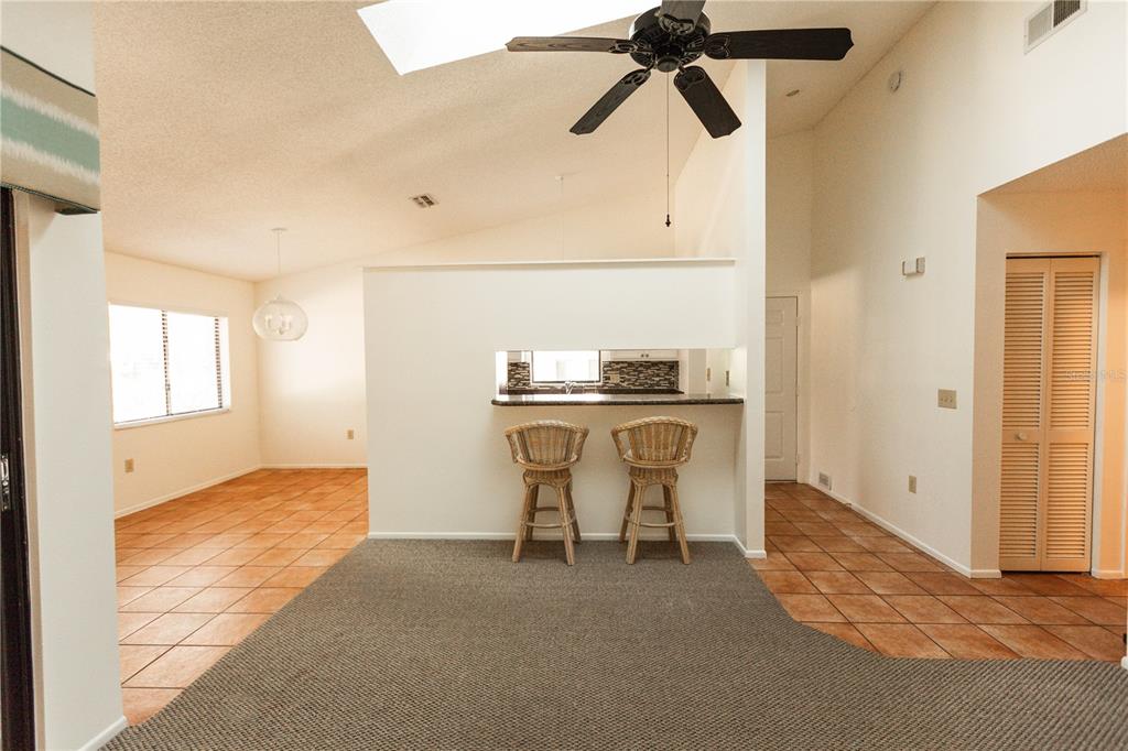 9410 Nakoma Way, Unit H Weeki Wachee, FL 34613 - Photo 12 of 29 a view of a kitchen with furniture and a window