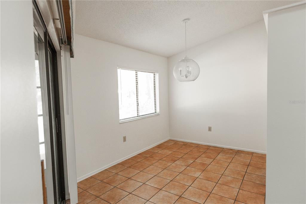 9410 Nakoma Way, Unit H Weeki Wachee, FL 34613 - Photo 14 of 29 a view of an empty room and window