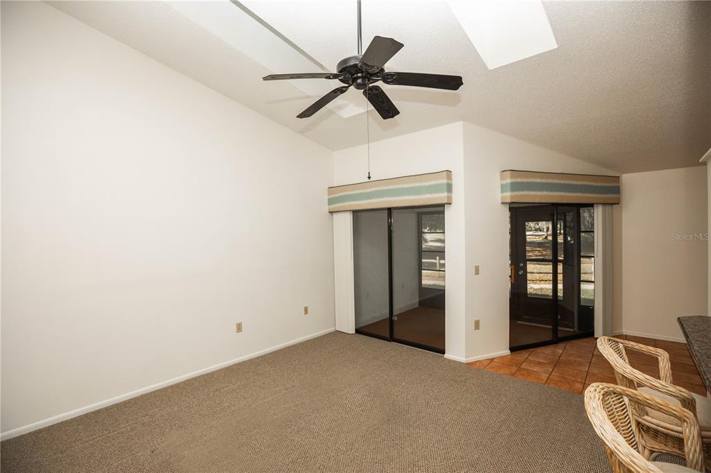 9410 Nakoma Way, Unit H Weeki Wachee, FL 34613 - Photo 15 of 29 a view of a room with a ceiling fan and wooden floor