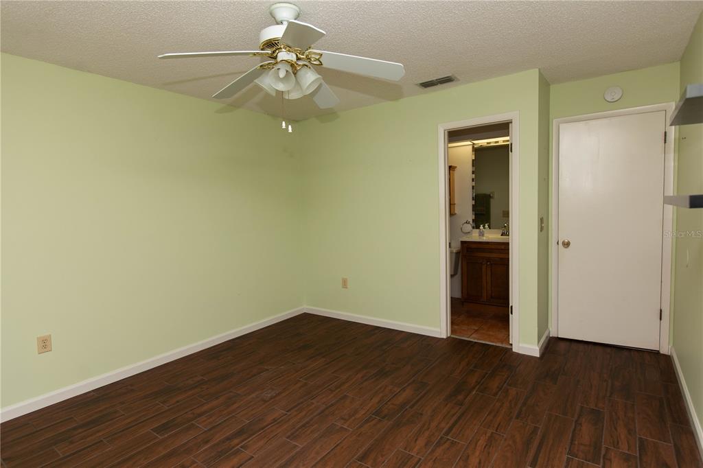 9410 Nakoma Way, Unit H Weeki Wachee, FL 34613 - Photo 19 of 29 a view of a room with wooden floor and closet
